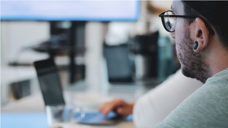 a man looking at a computer screen