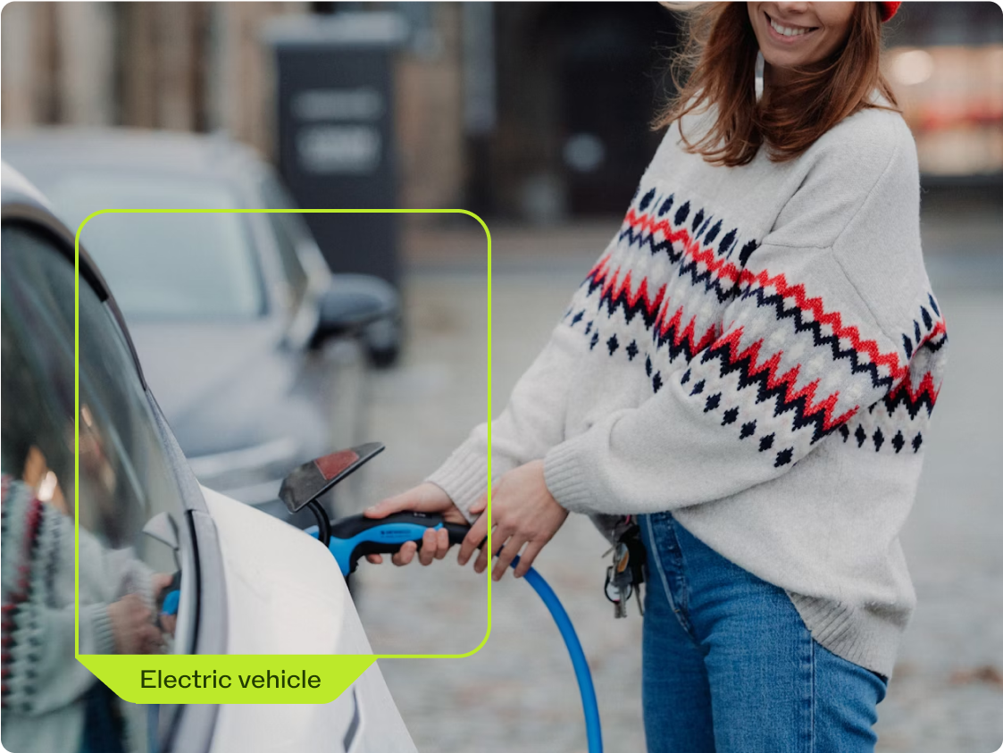 a woman charging an electric car
