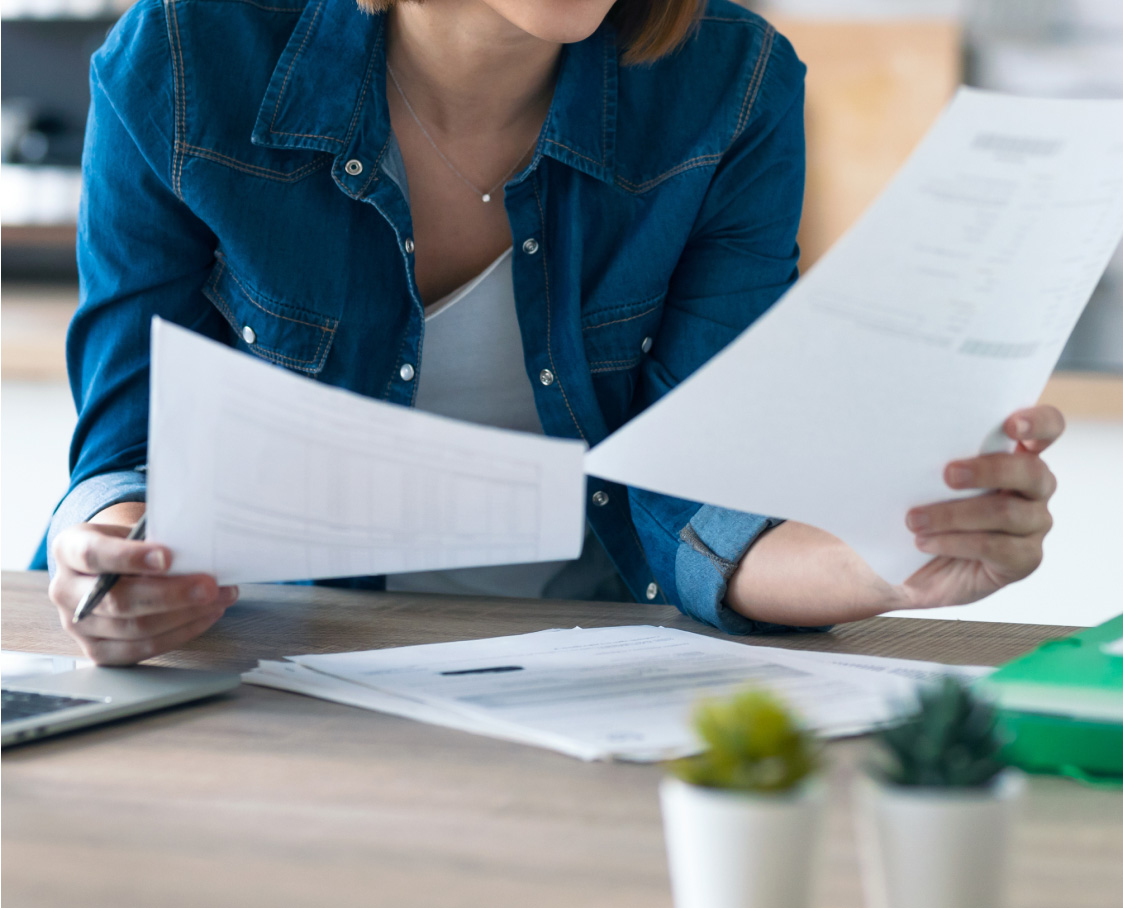 Woman checking documents at desk