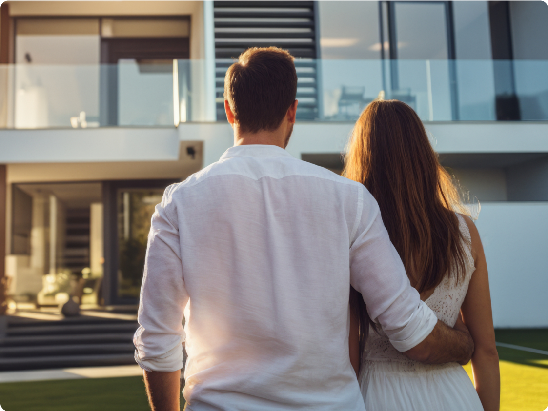 Couple standing in front of apartment block