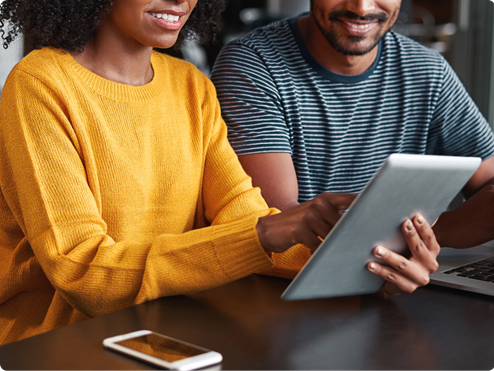 Couple using tablet to salary package