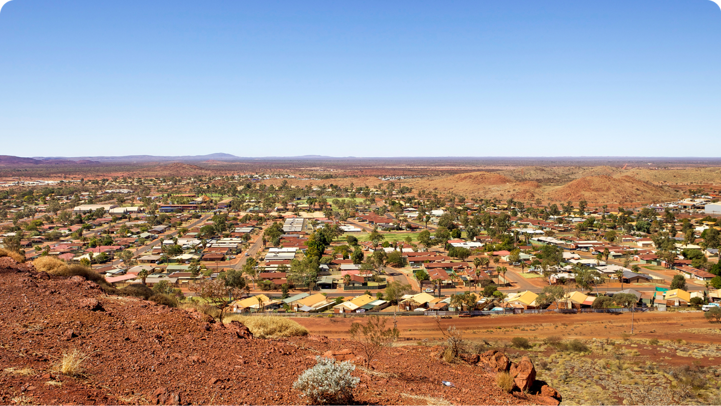 A distant shot of a rural town with the horizon pin the background. 