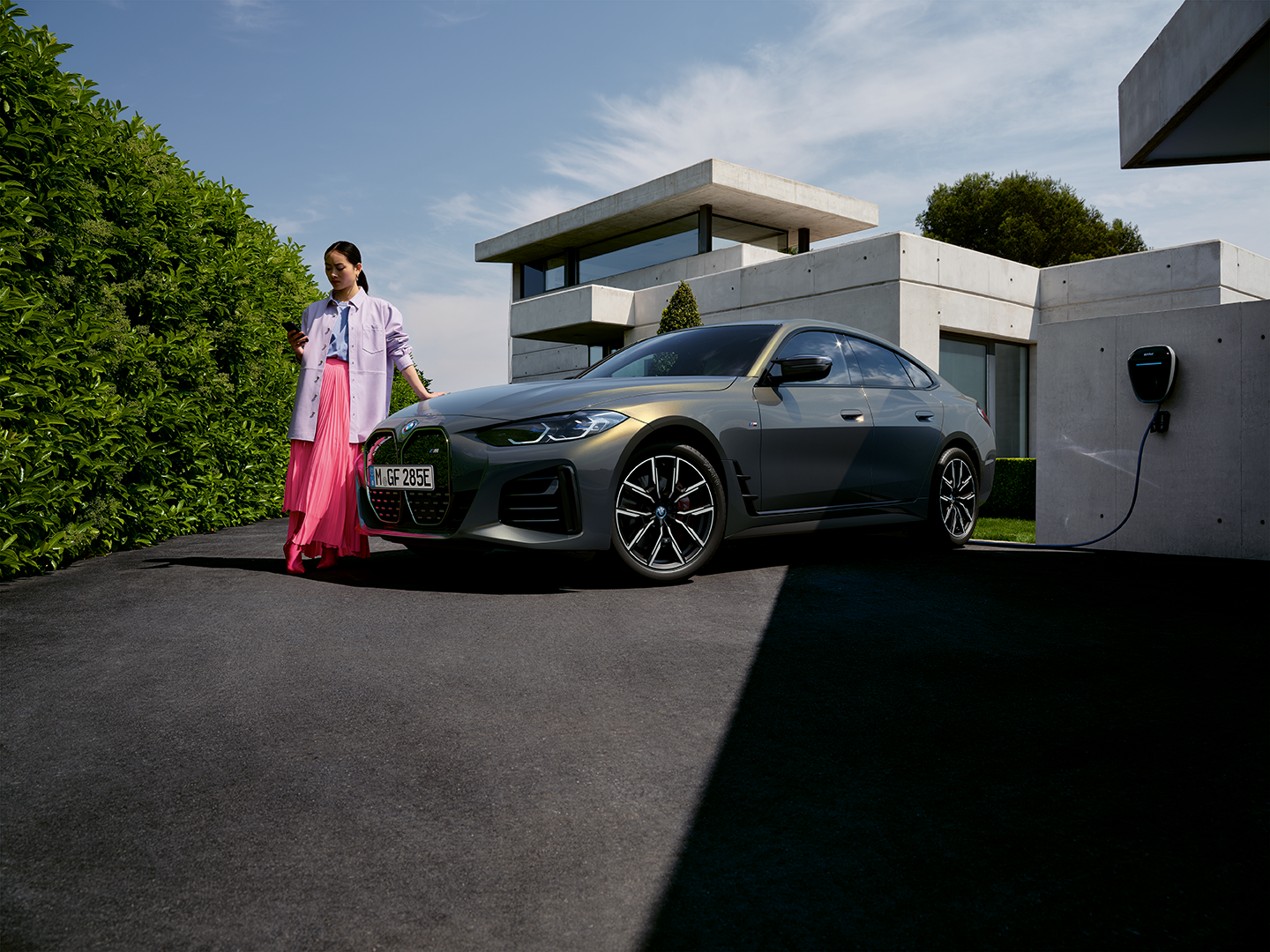 BMW electric sedan parked near a charging station